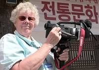 Val Ellis with camcorder.