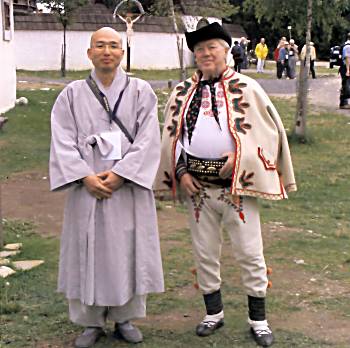 Magazine cover picture of Korean monk and Slovak in traditional costume.