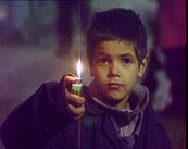 Faked news image of a street kid in Romania with candle.