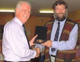 Reg Lancaster presenting a medal to Dave Watterson.