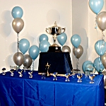 The table full of trophies. 