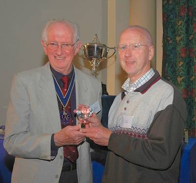 Reg Lancaster presents the award to Neil Cryer.