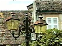 Photo of twin lamps on a post in Beaume, France.