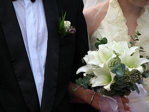 Photo of a couple's hands clasped.